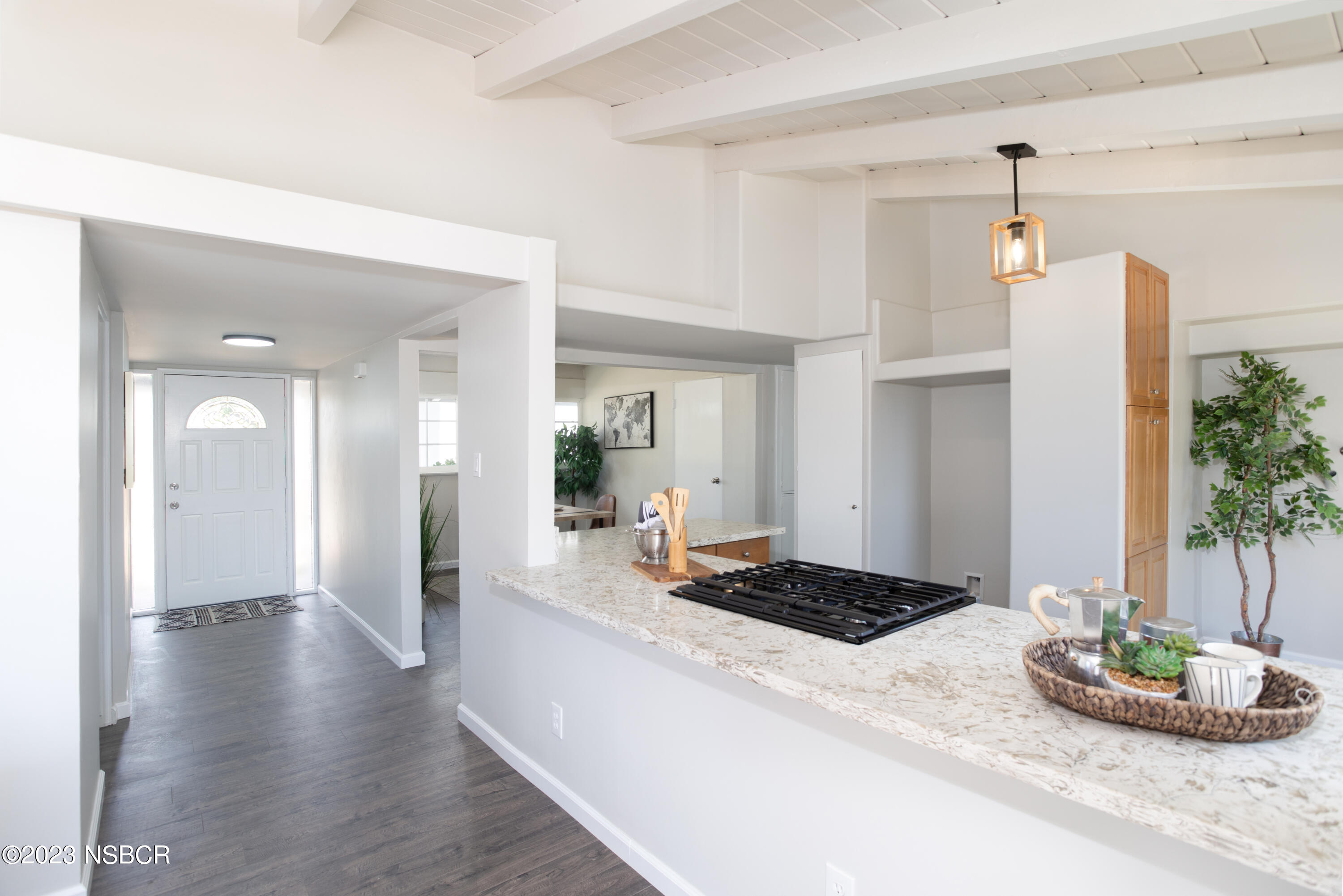 303 North Third Street Lompoc, CA 93436 - Photo 7 of 31 a kitchen with a refrigerator and a wooden floor