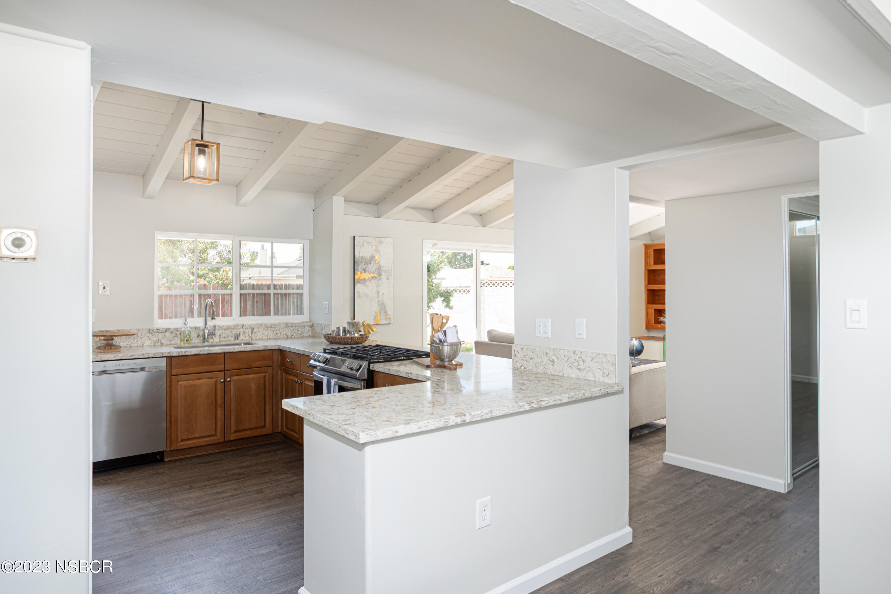 303 North Third Street Lompoc, CA 93436 - Photo 9 of 31 a kitchen with a sink stove and refrigerator
