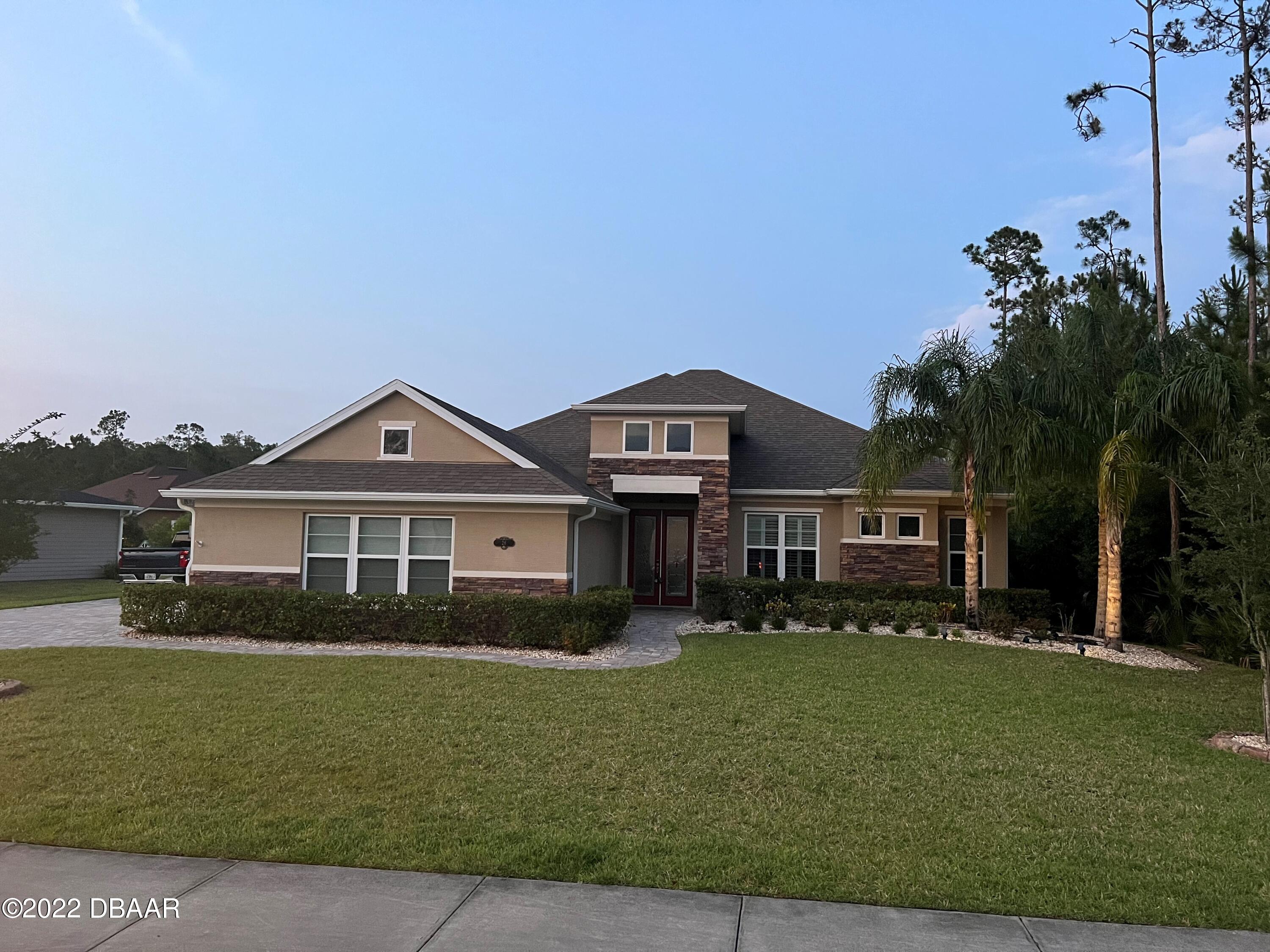 a front view of a house with a yard