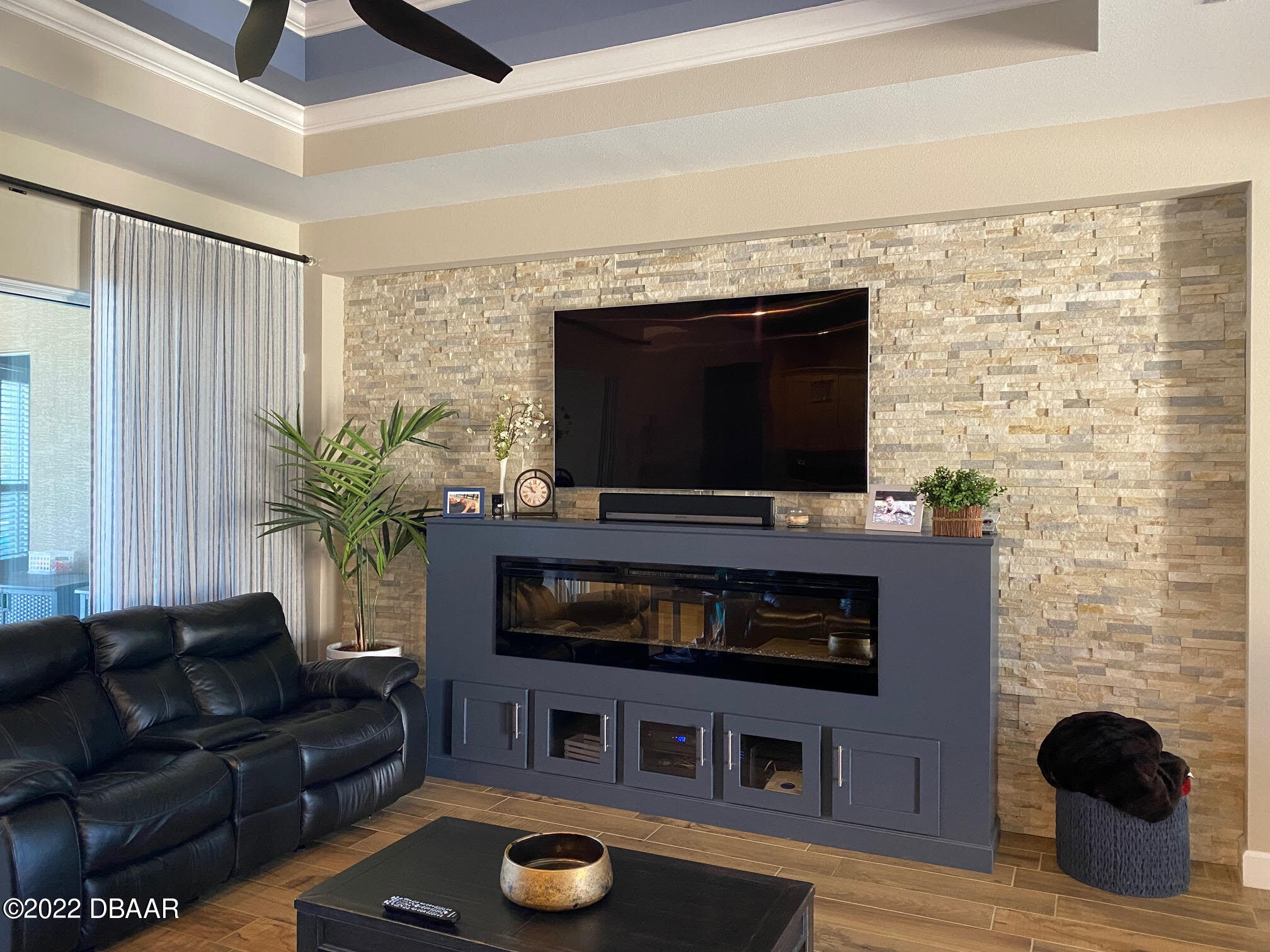 26 Ashford Lakes Drive Ormond Beach, FL 32174 - Photo 11 of 25 a living room with furniture a flat screen tv and a fireplace