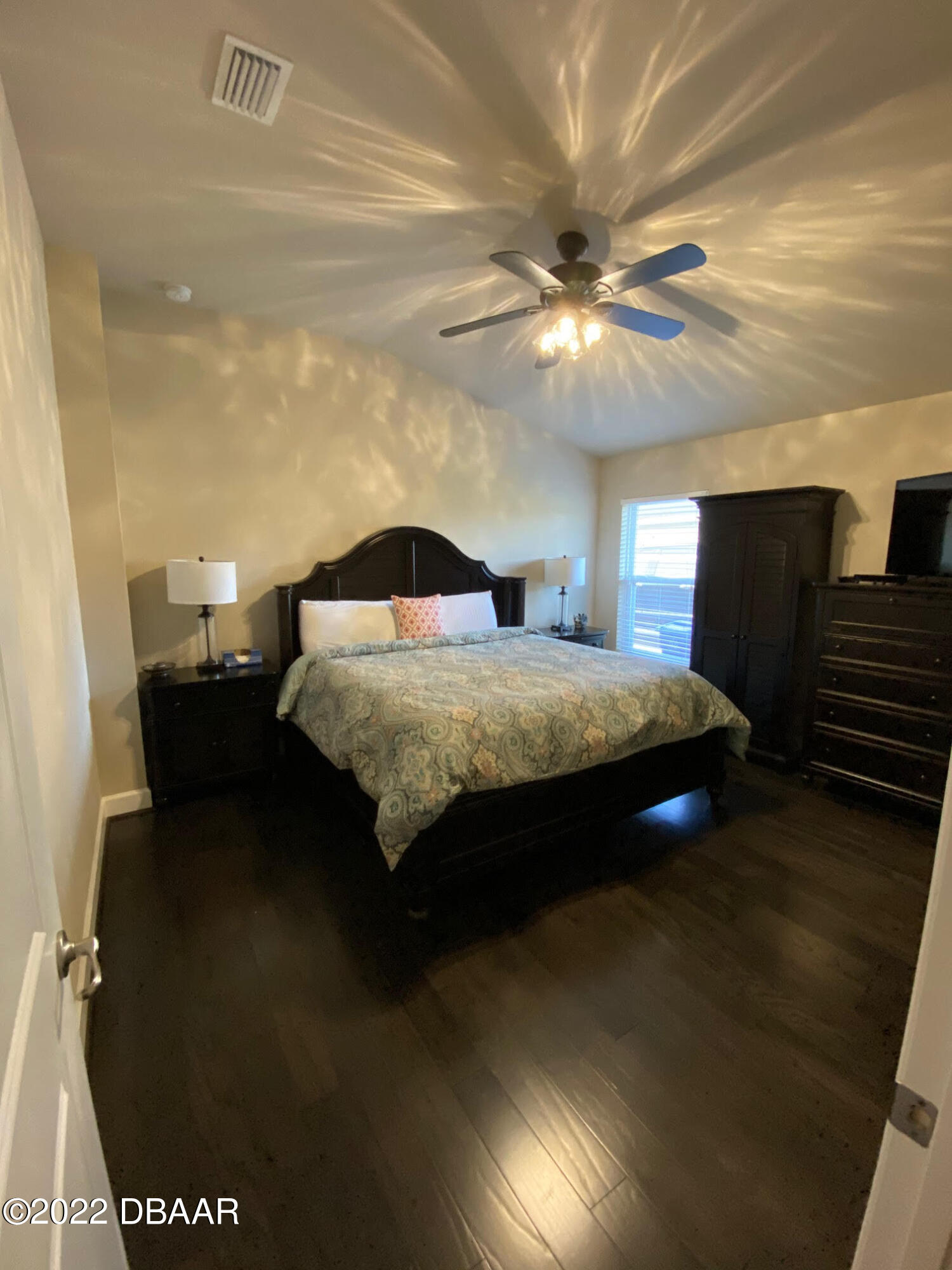 26 Ashford Lakes Drive Ormond Beach, FL 32174 - Photo 15 of 25 a bedroom with a bed and a chandelier