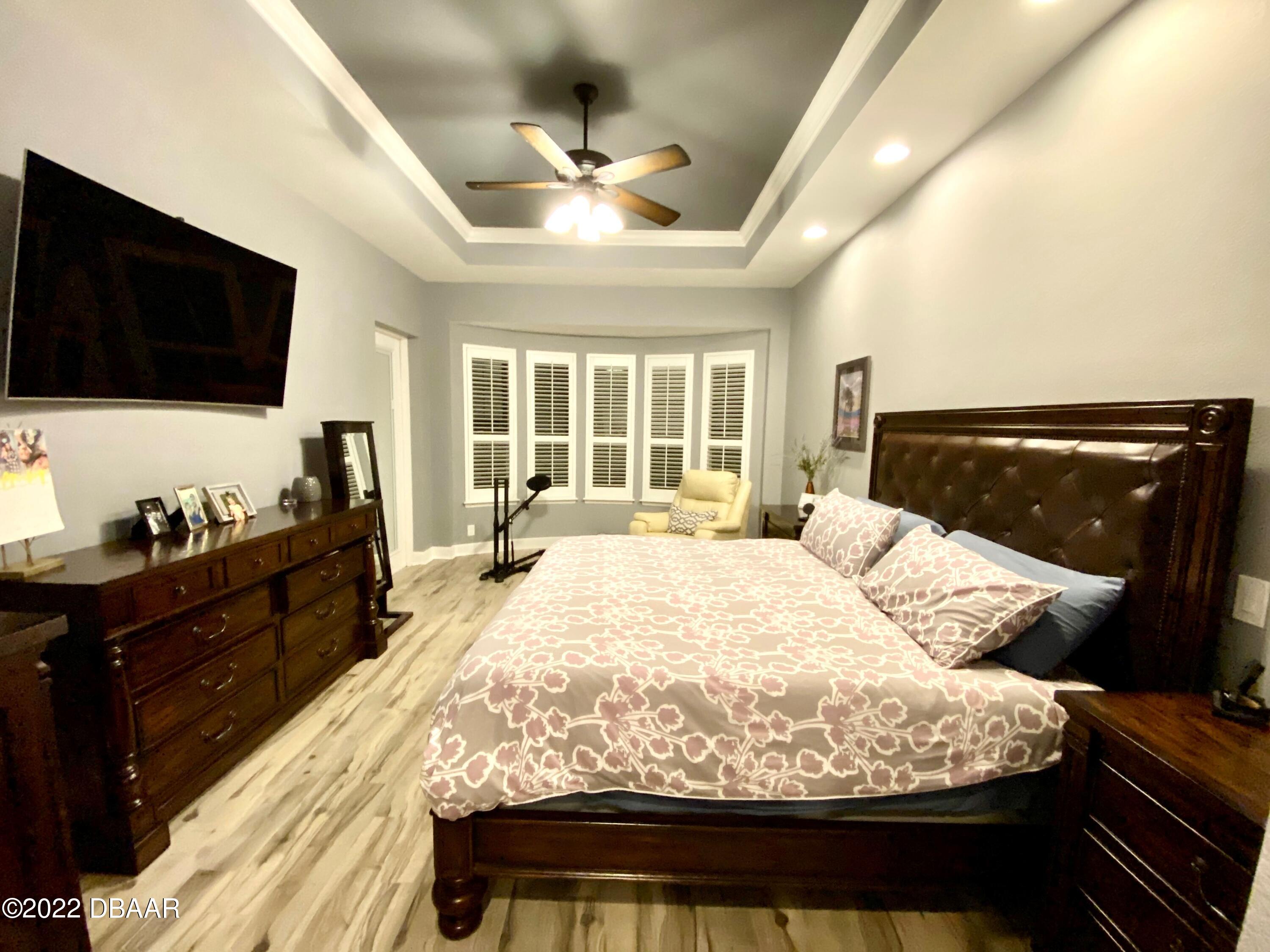 26 Ashford Lakes Drive Ormond Beach, FL 32174 - Photo 17 of 25 a bed sitting in a bedroom and a flat screen tv