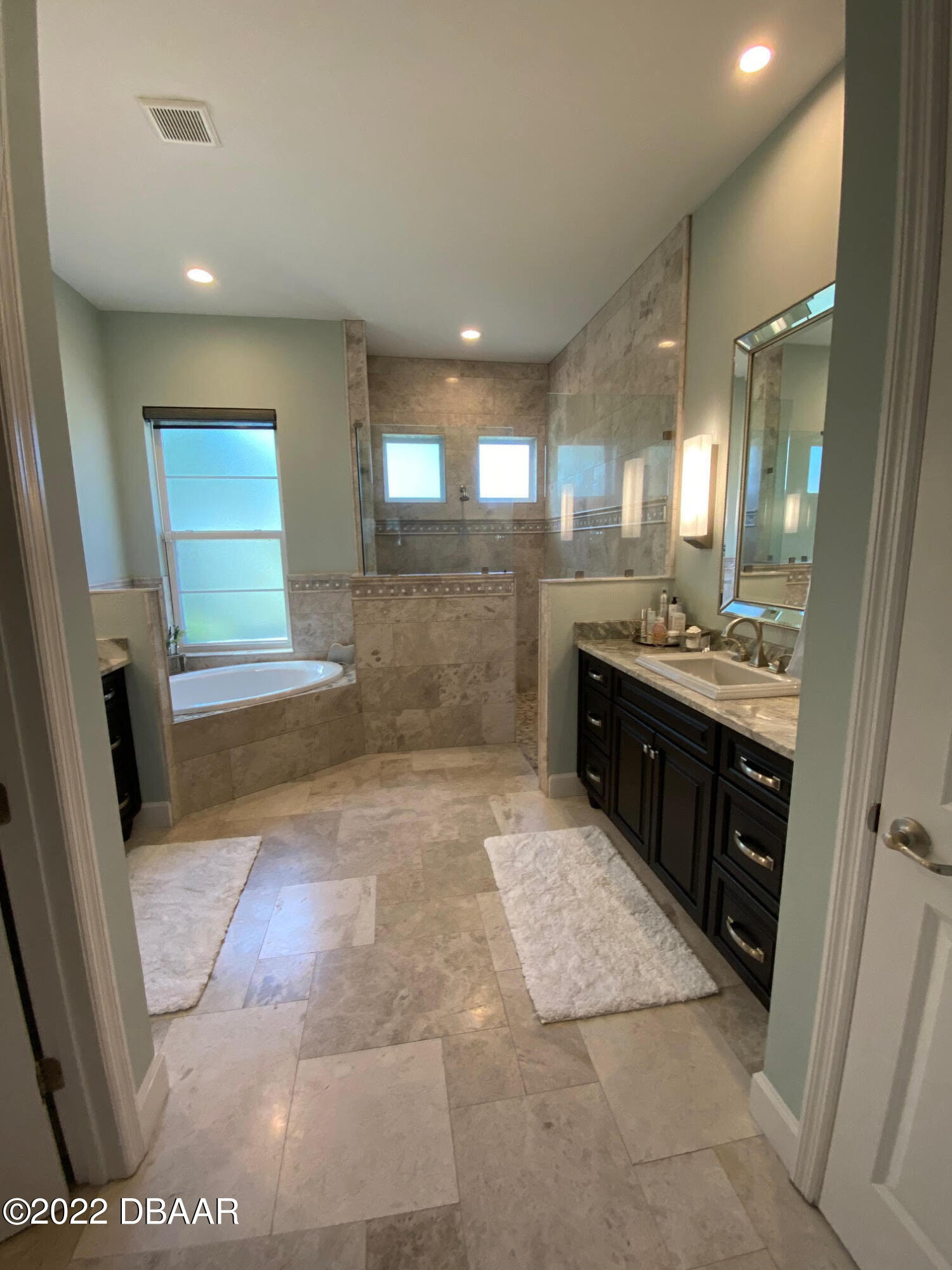 26 Ashford Lakes Drive Ormond Beach, FL 32174 - Photo 18 of 25 a bathroom with a sink a toilet and mirror