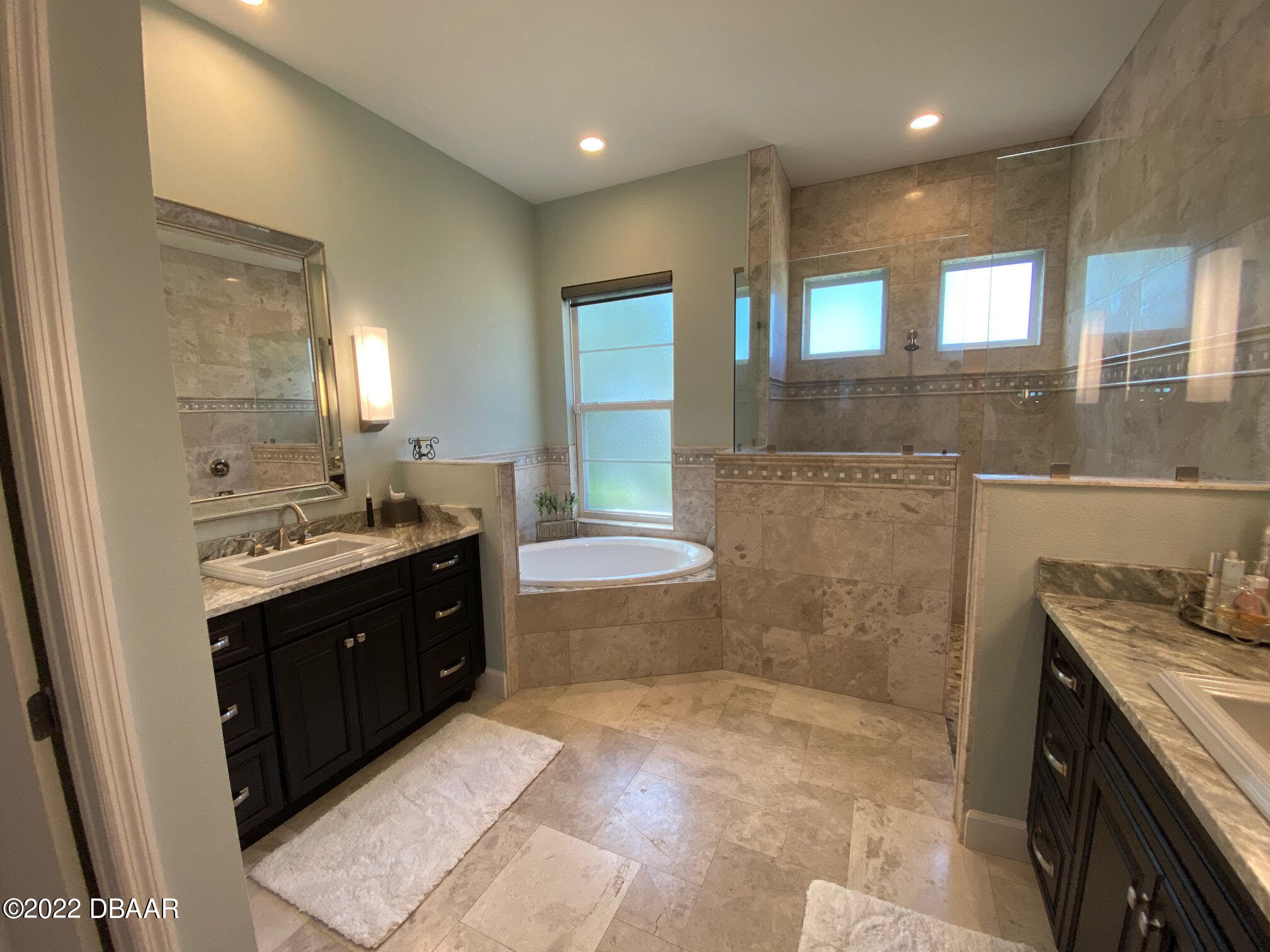 26 Ashford Lakes Drive Ormond Beach, FL 32174 - Photo 19 of 25 a bathroom with a granite countertop sink a toilet and mirror