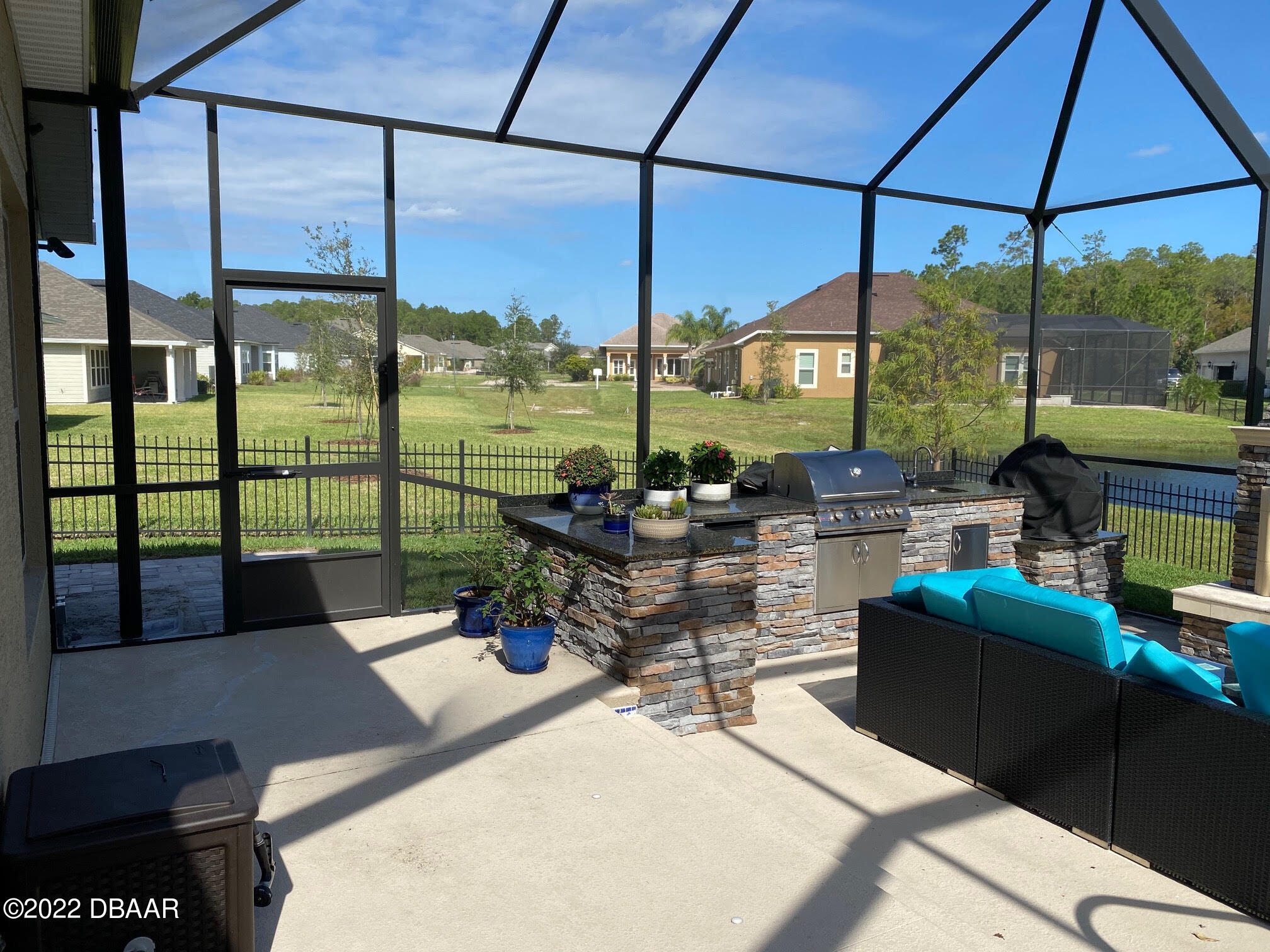 26 Ashford Lakes Drive Ormond Beach, FL 32174 - Photo 21 of 25 a living room with patio furniture and floor to ceiling windows