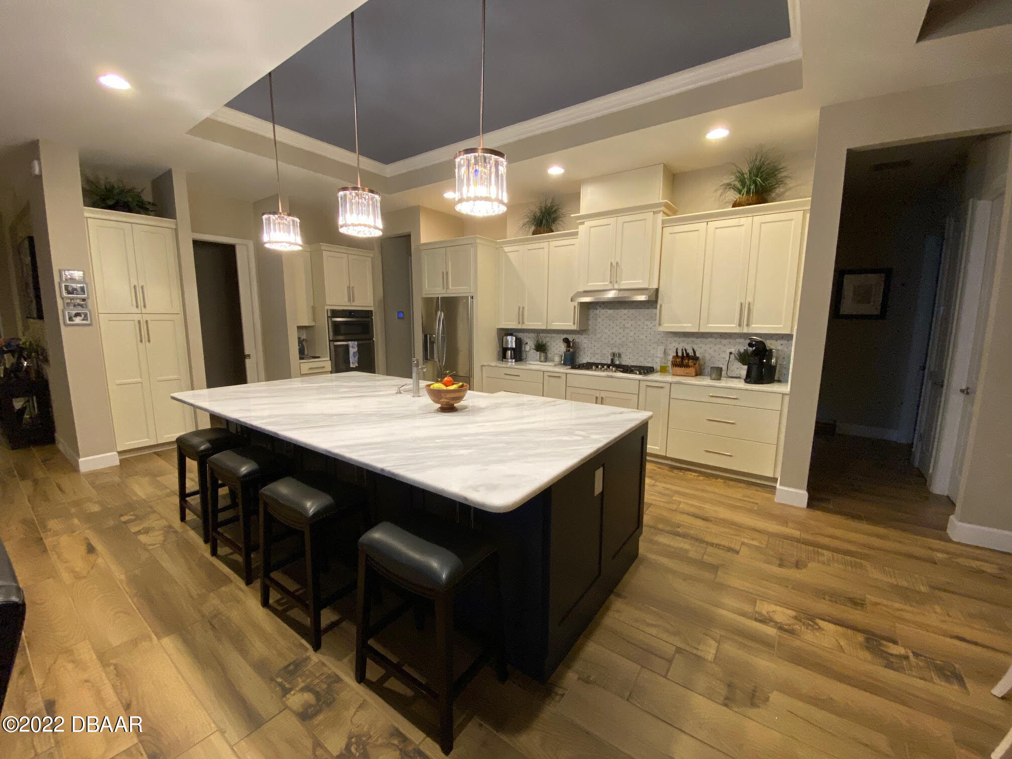 26 Ashford Lakes Drive Ormond Beach, FL 32174 - Photo 4 of 25 a kitchen with stainless steel appliances kitchen island a cabinets and wooden floor