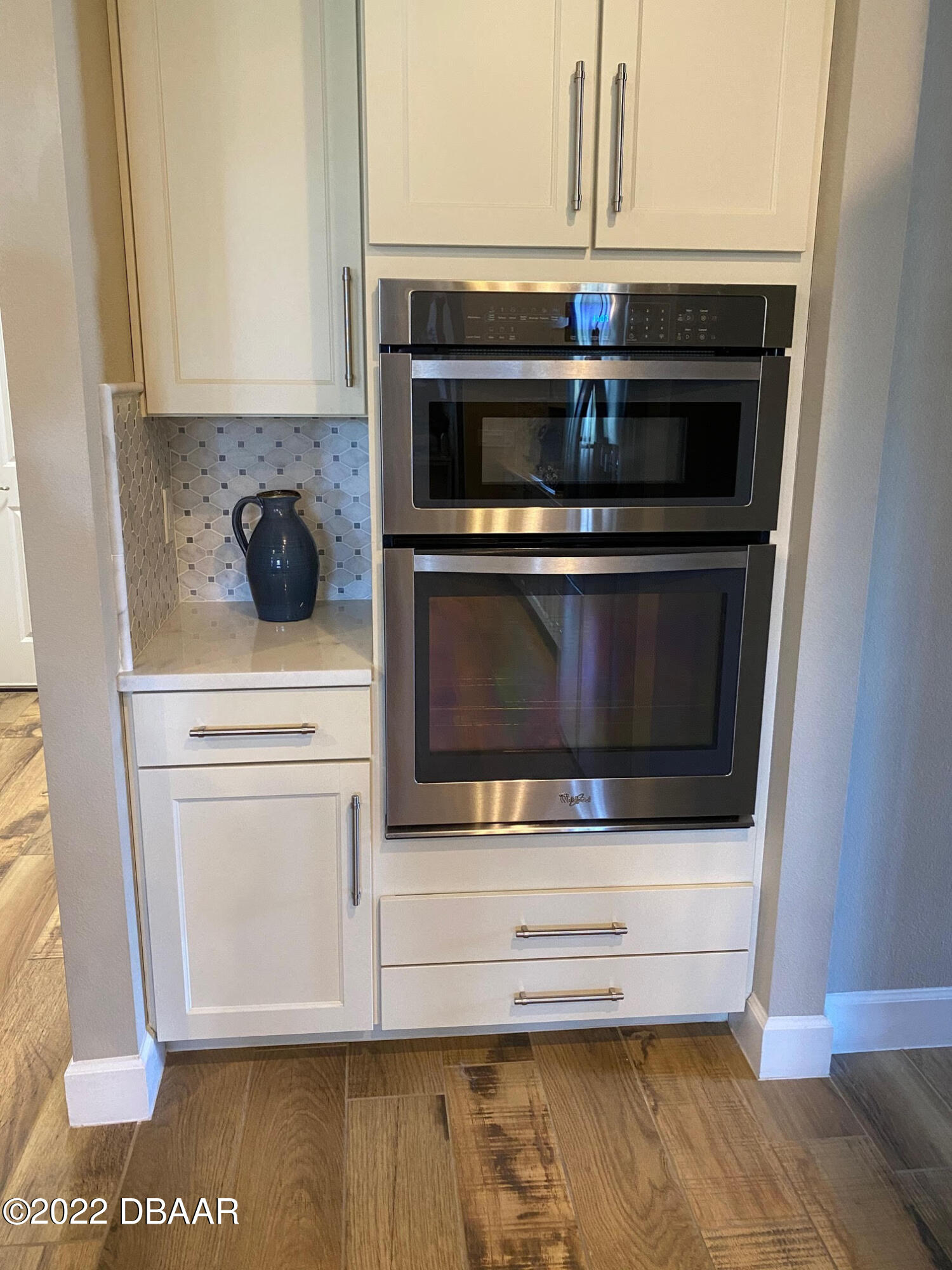 26 Ashford Lakes Drive Ormond Beach, FL 32174 - Photo 6 of 25 a kitchen with stainless steel appliances wooden cabinets and a stove