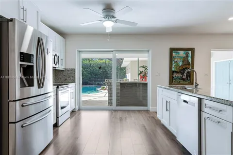 a kitchen with stainless steel appliances a refrigerator and a stove top oven