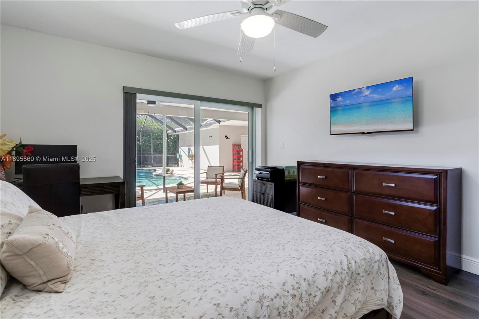 13905 Southwest 78th Court Palmetto Bay, FL 33158 - Photo 14 of 32 a bedroom with a bed and a dresser