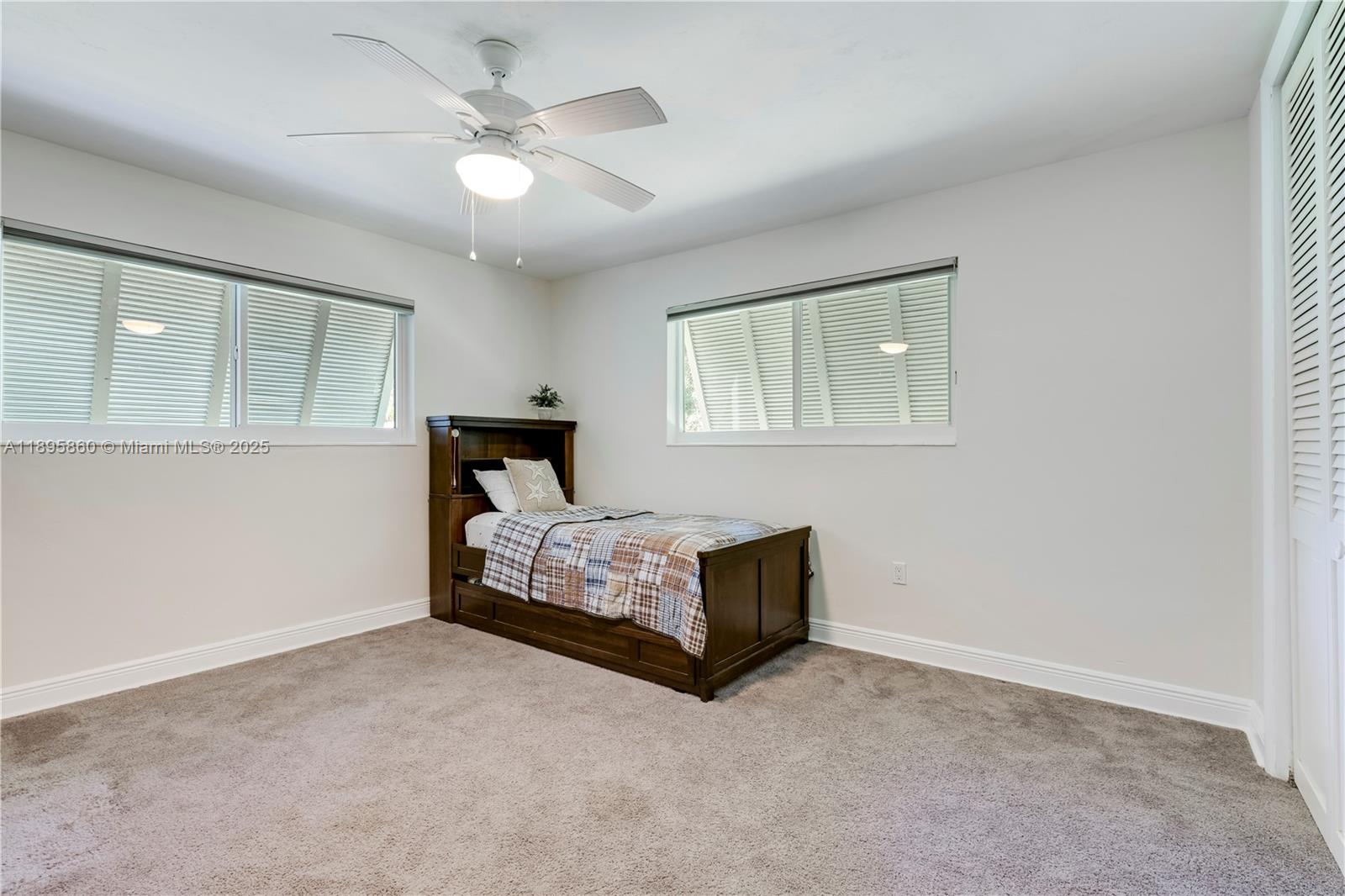 13905 Southwest 78th Court Palmetto Bay, FL 33158 - Photo 17 of 32 a living room with furniture and a ceiling fan