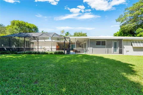 a view of a house with a backyard and a patio