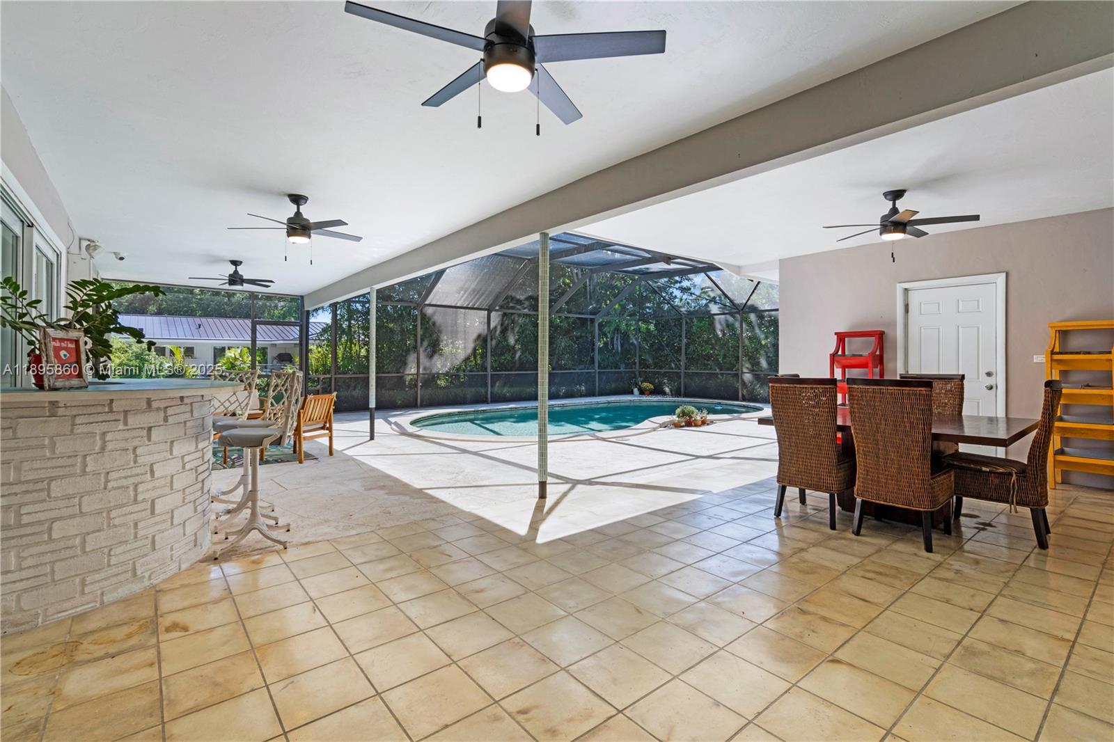 13905 Southwest 78th Court Palmetto Bay, FL 33158 - Photo 3 of 32 a living room with a table and chairs