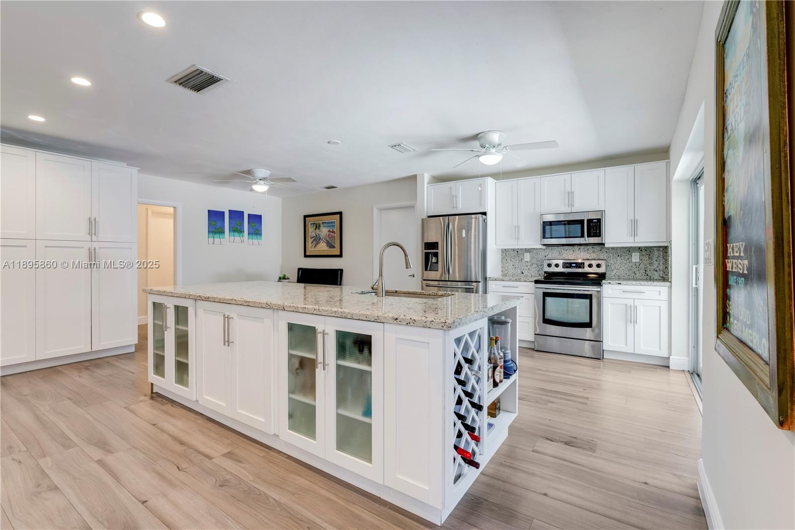 13905 Southwest 78th Court Palmetto Bay, FL 33158 - Photo 10 of 32 a kitchen with stainless steel appliances granite countertop a stove and a refrigerator