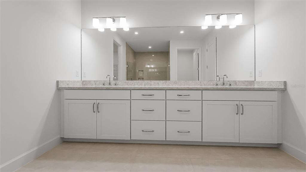 1615 Bellagio Loop Tavares, FL 32778 - Photo 12 of 39 a bathroom with a sink vanity and a mirror