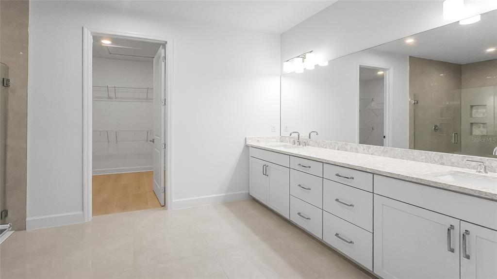 1615 Bellagio Loop Tavares, FL 32778 - Photo 17 of 39 a bathroom with a double vanity sink and a mirror