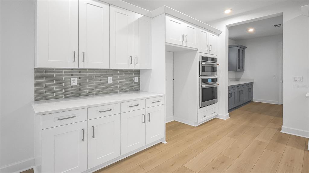 1615 Bellagio Loop Tavares, FL 32778 - Photo 6 of 39 a kitchen with stainless steel appliances white cabinets and a refrigerator