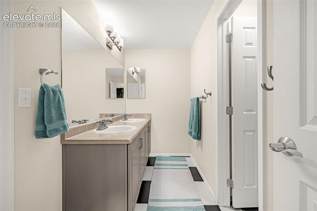 9127 Oakmont Road Peyton, CO 80831 - Photo 29 of 49 a bathroom with a sink and mirror