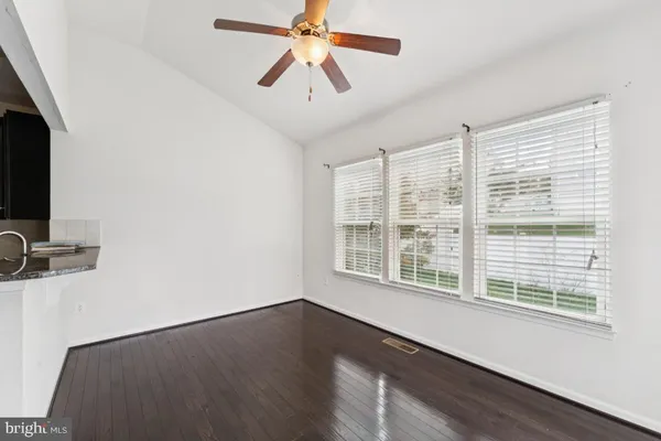 a view of a livingroom with a ceiling fan and a window