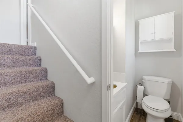 a white toilet sitting next to a small bathroom