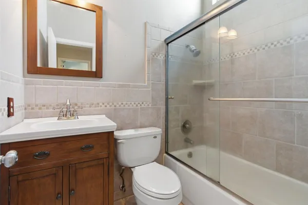 a bathroom with a sink mirror toilet and bathtub