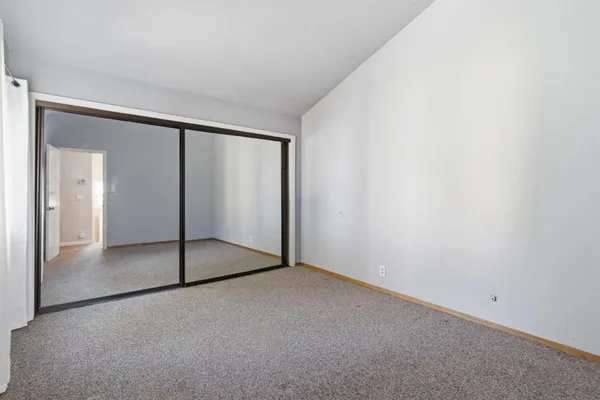 a view of an empty room with glass door