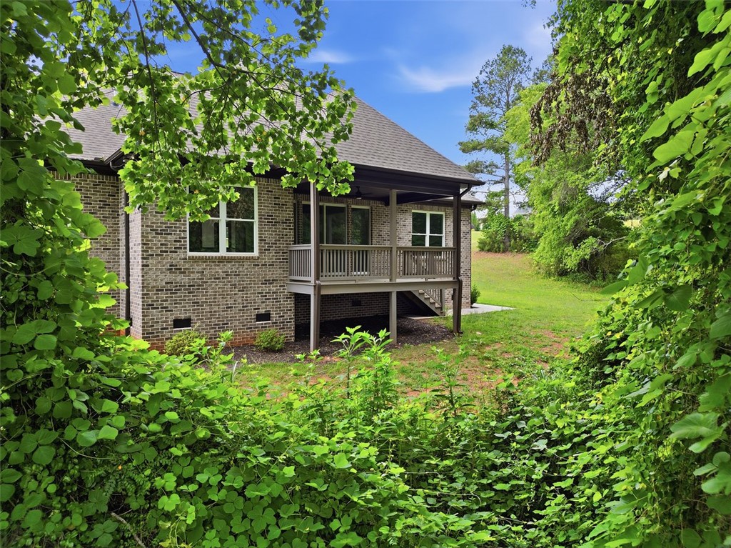 105 Bree Drive Anderson, SC 29621 - Photo 6 of 48 Brick exterior offers a private deck, nestled amongst verdant foliage.