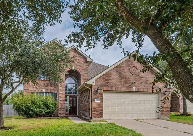 a view of house with a yard