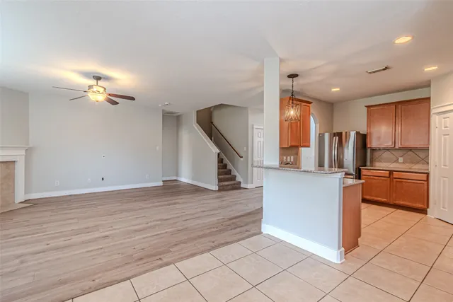 a view of a kitchen with kitchen island stainless steel appliances refrigerator stove microwave and cabinets