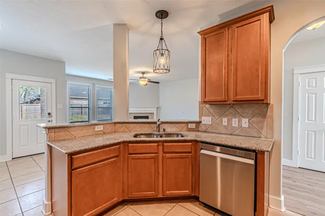 a kitchen with stainless steel appliances granite countertop cabinets and wooden floor