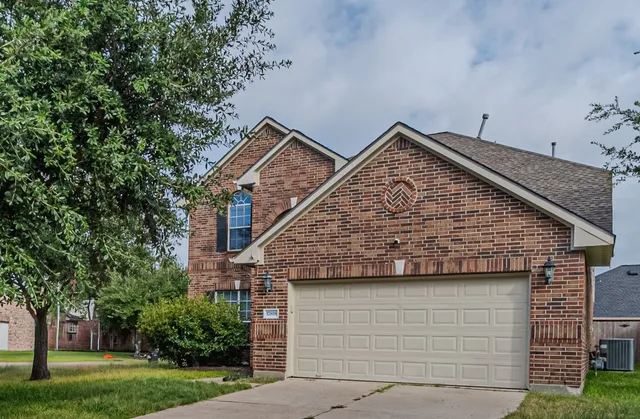 a view of a brick house with a door and wooden floor