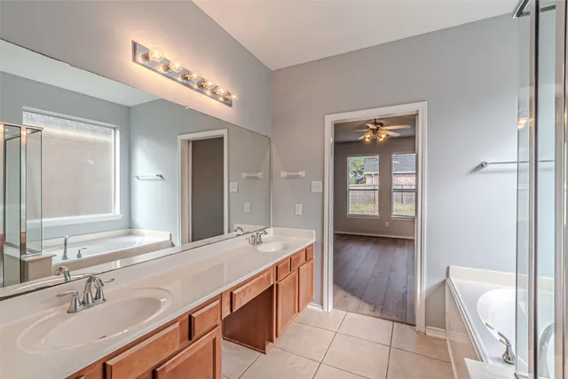 a spacious bathroom with a sink a vanity and a mirror