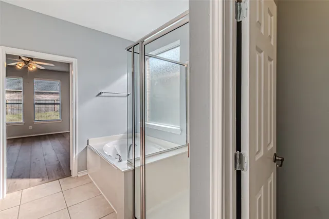 a bathroom with a tub and shower