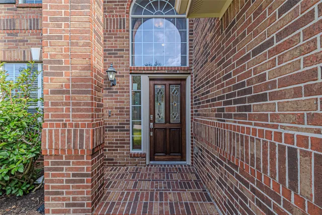 a view of a brick house with a door and wooden floor