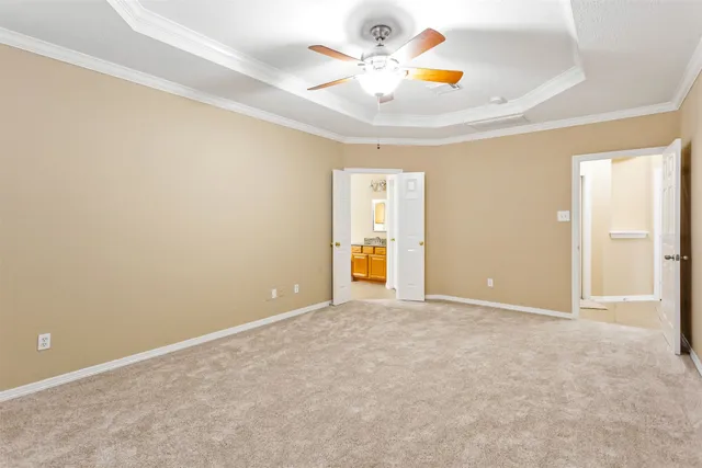 an empty room with closet and a chandelier fan