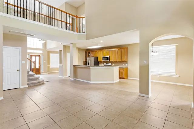 a view of a kitchen with furniture and an empty room