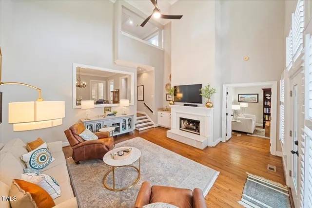 a living room with furniture a fireplace and a flat screen tv