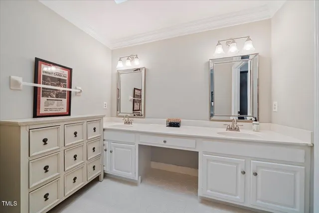 a bathroom with double sink and a mirror