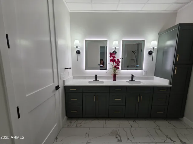 a bathroom with a double vanity sink and mirror