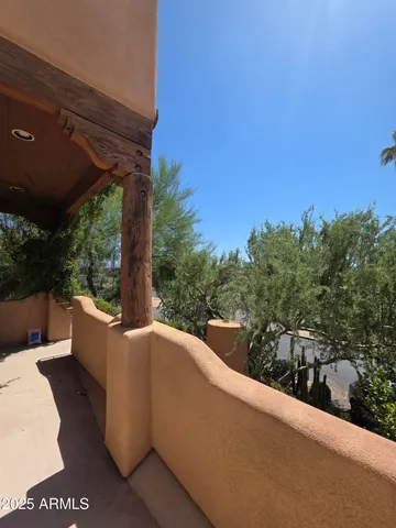 a view of a patio with couches and wooden fence