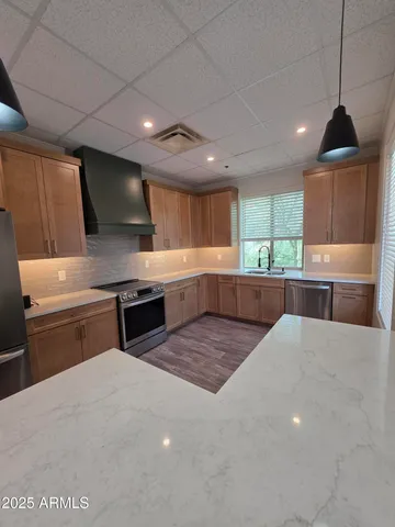 a kitchen with a stove a refrigerator and a sink