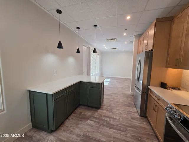 a kitchen with stainless steel appliances granite countertop a refrigerator and a sink