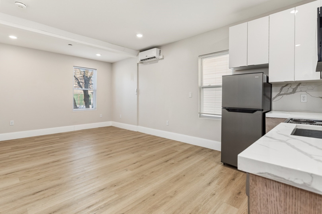 41 Wolcott Street, Unit 4 Everett, MA 02149 - Photo 13 of 19 a kitchen with a refrigerator and a stove top oven