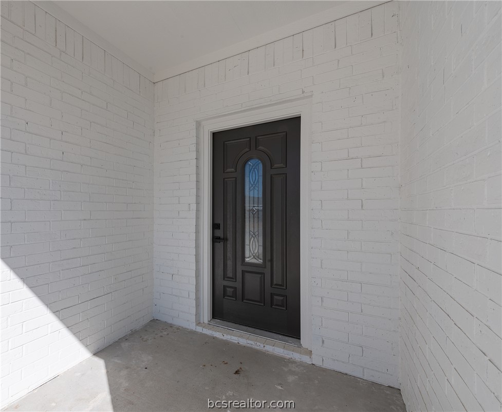 2908 GOLDBERG Drive Bryan, TX 77808 - Photo 5 of 44 Front door and elevation of the house featuring the front door with painted brick.