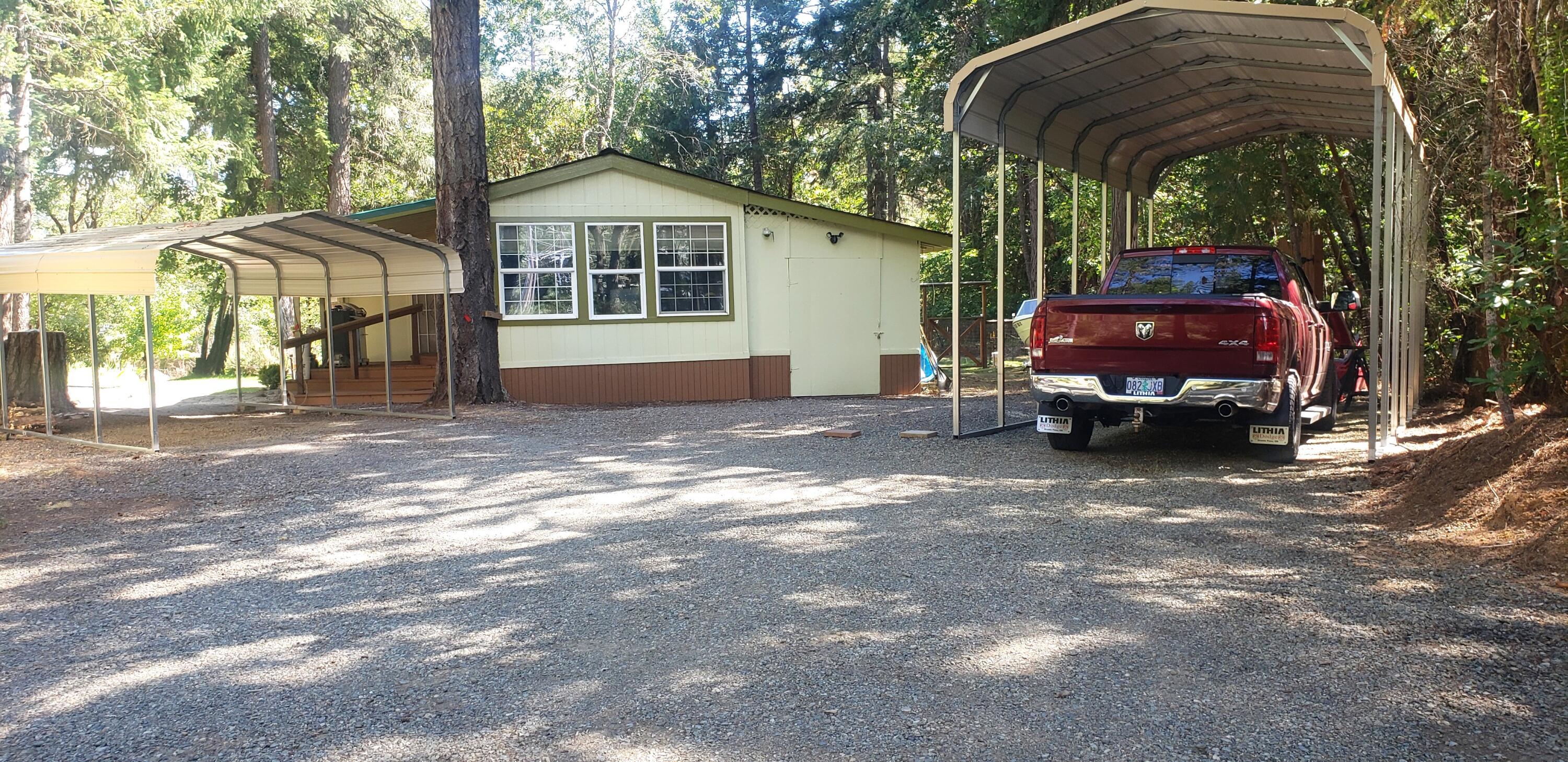 393 North Old Stage Road Cave Junction, OR 97523 - Photo 1 of 21 Front of home, RV port & one other stnless steal canopy.