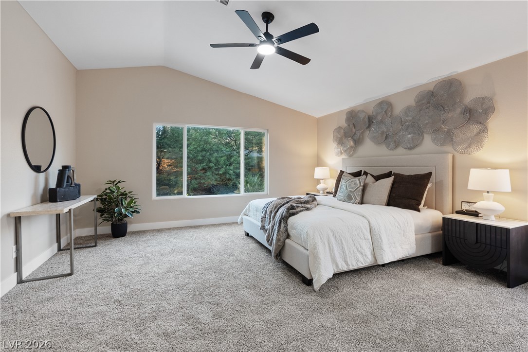 1662 Ravanusa Drive Henderson, NV 89052 - Photo 41 of 74 A quiet bedroom with vaulted ceilings and ample natural light offers a serene escape.
