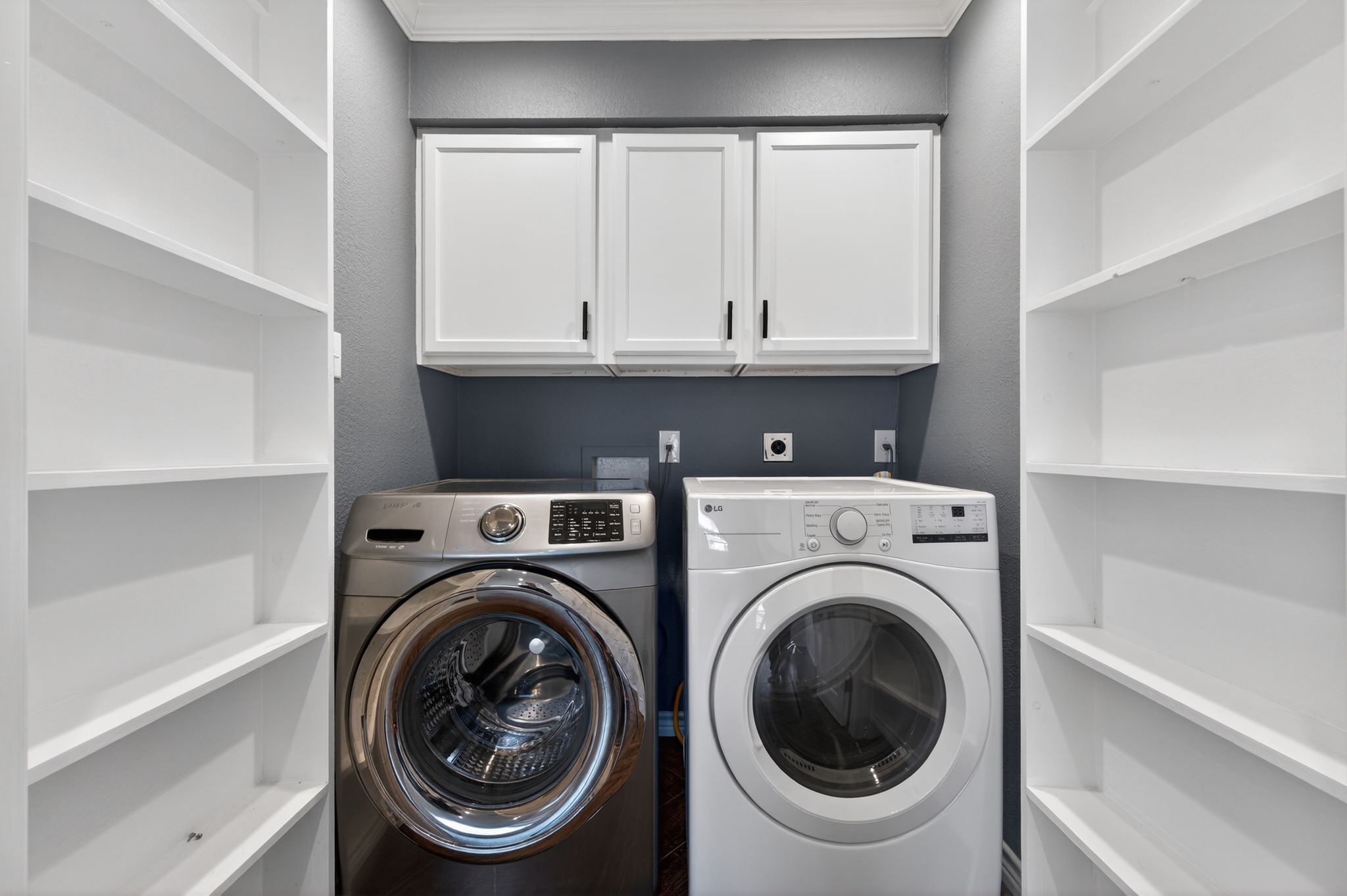 1201 Dillon Lake Bend Leander, TX 78641 - Photo 15 of 38 Laundry room featuring washing machine and clothes dryer and cabinet space