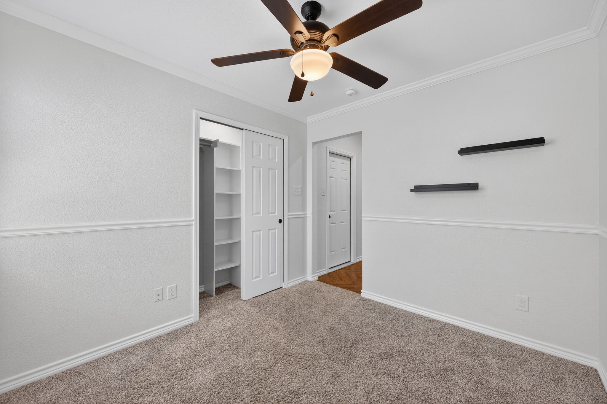 1201 Dillon Lake Bend Leander, TX 78641 - Photo 23 of 38 Bedroom featuring carpet flooring, ornamental molding, a closet, and a ceiling fan