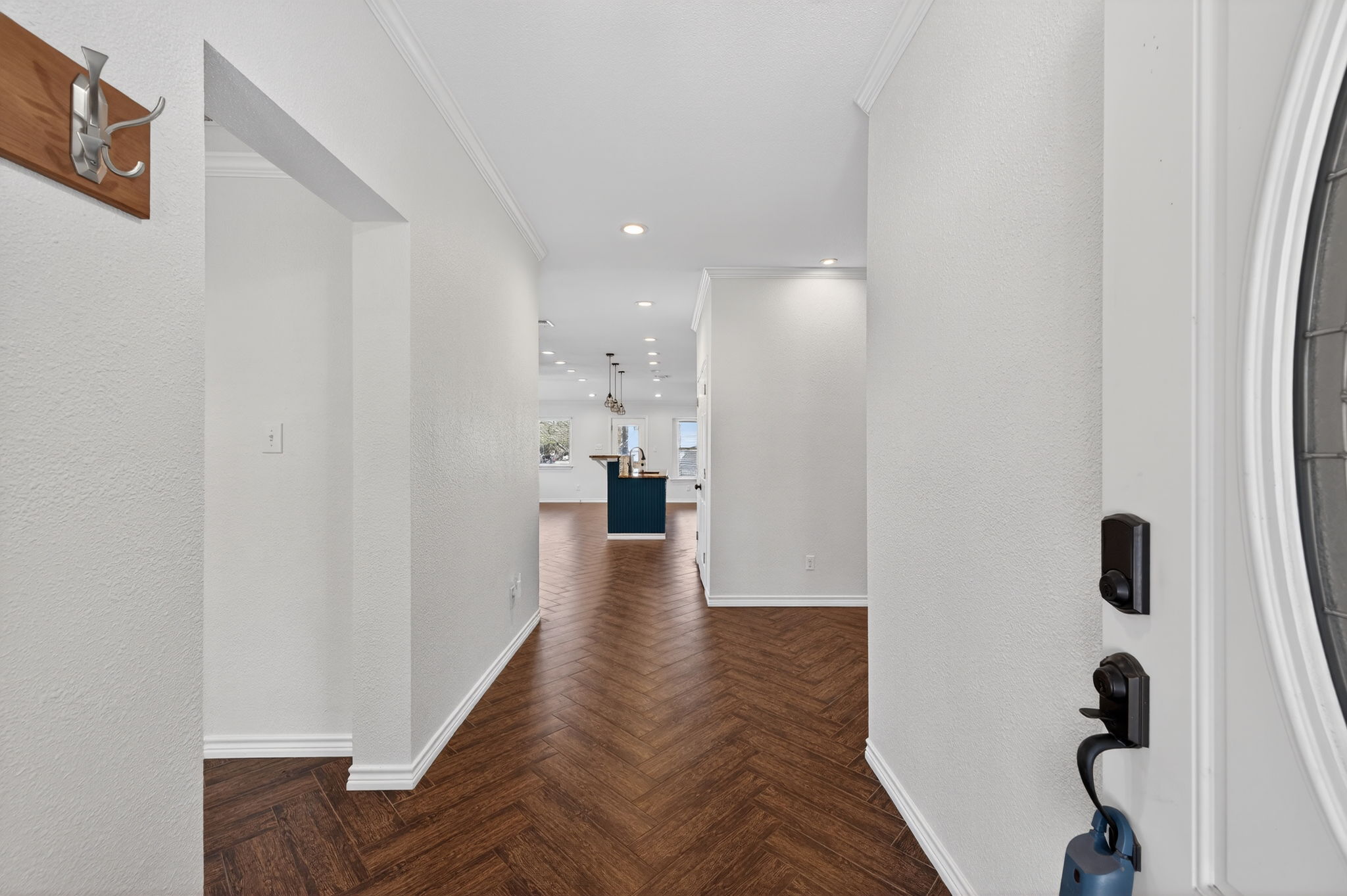 1201 Dillon Lake Bend Leander, TX 78641 - Photo 4 of 38 Hallway with ornamental molding, parquet flooring, recessed lighting, and a textured wall