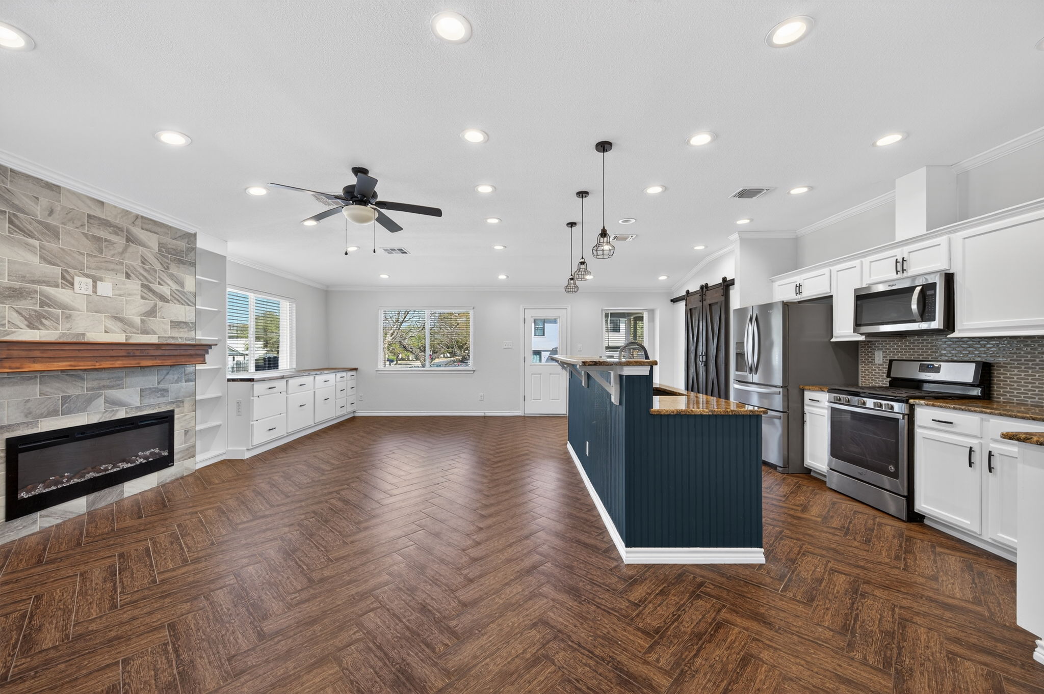 1201 Dillon Lake Bend Leander, TX 78641 - Photo 36 of 38 Kitchen with open floor plan, white cabinetry, stainless steel appliances, hanging light fixtures, and a barn door Pantry