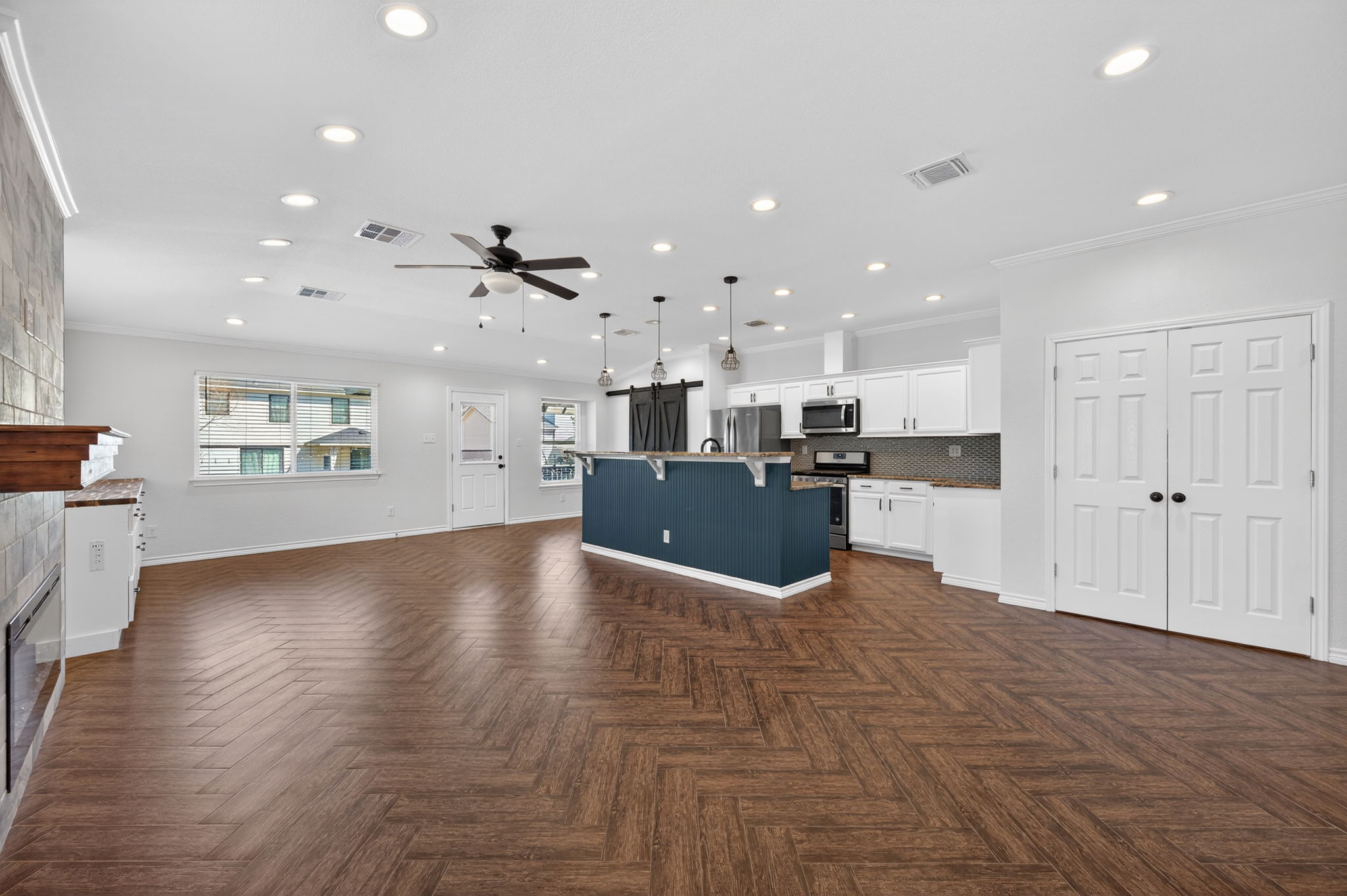 1201 Dillon Lake Bend Leander, TX 78641 - Photo 7 of 38 Living room featuring ornamental molding, a ceiling fan, a tile fireplace, recessed lighting, and parquet floors